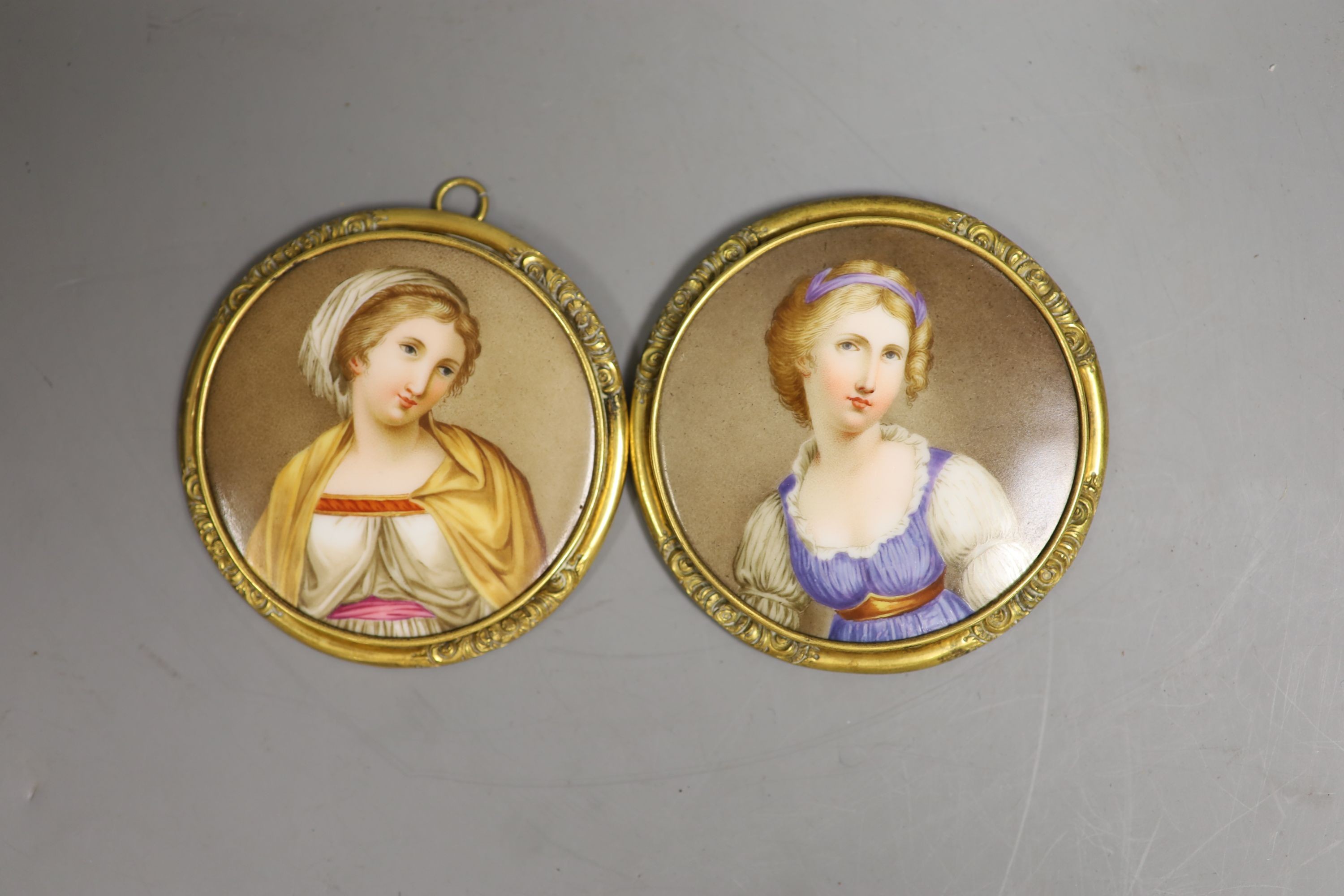 A pair of 19th century German porcelain circular portrait plaques, 7cm diameter